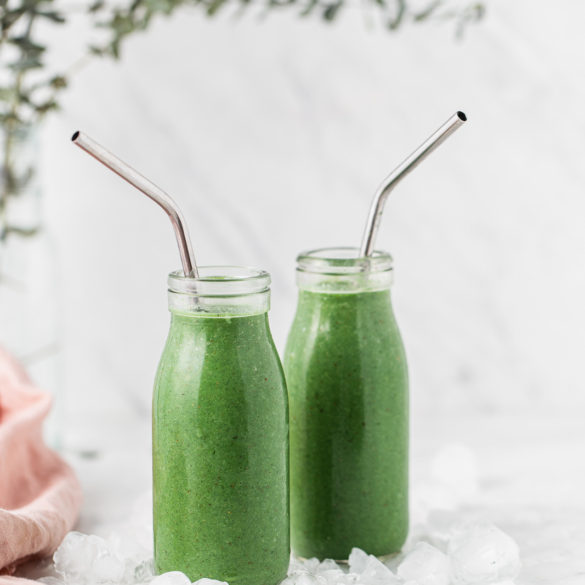 green smoothies in jars with a straw