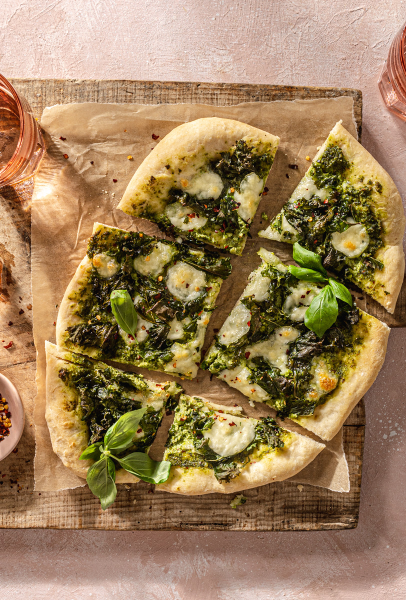kale pesto pizza on wooden board food photography