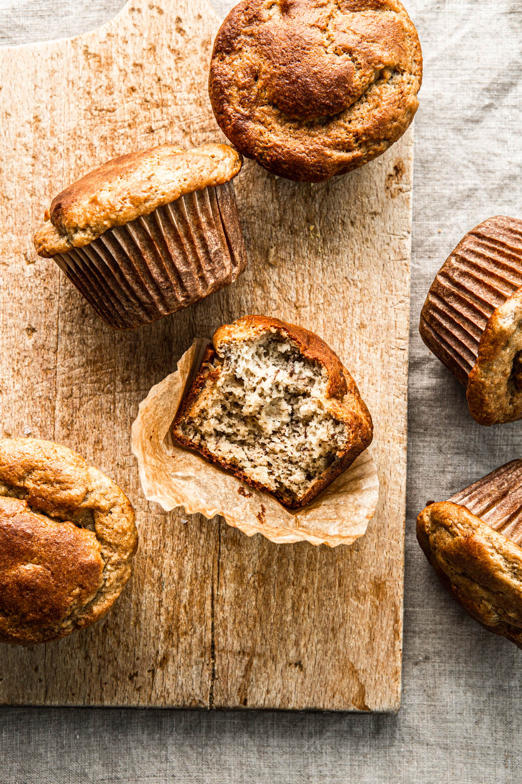 almond flour paleo muffins on a wooden board with a bite taken out food photography