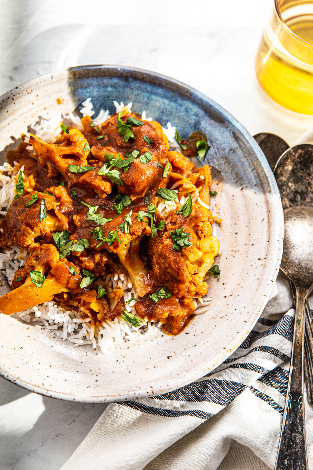 indian cauliflower curry with basmati rice and cilantro photography