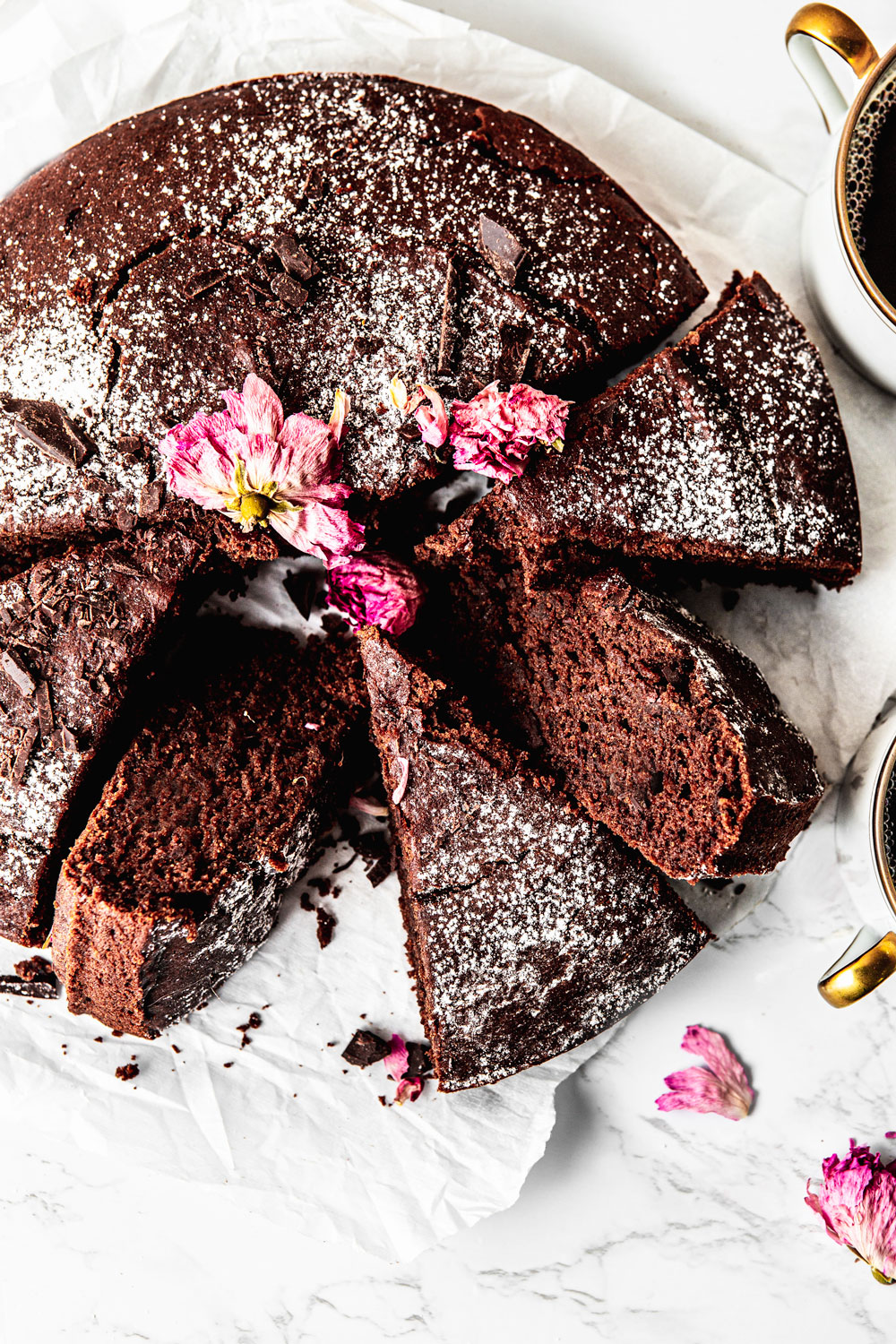 moist chocolate cake with cut up slices food photography