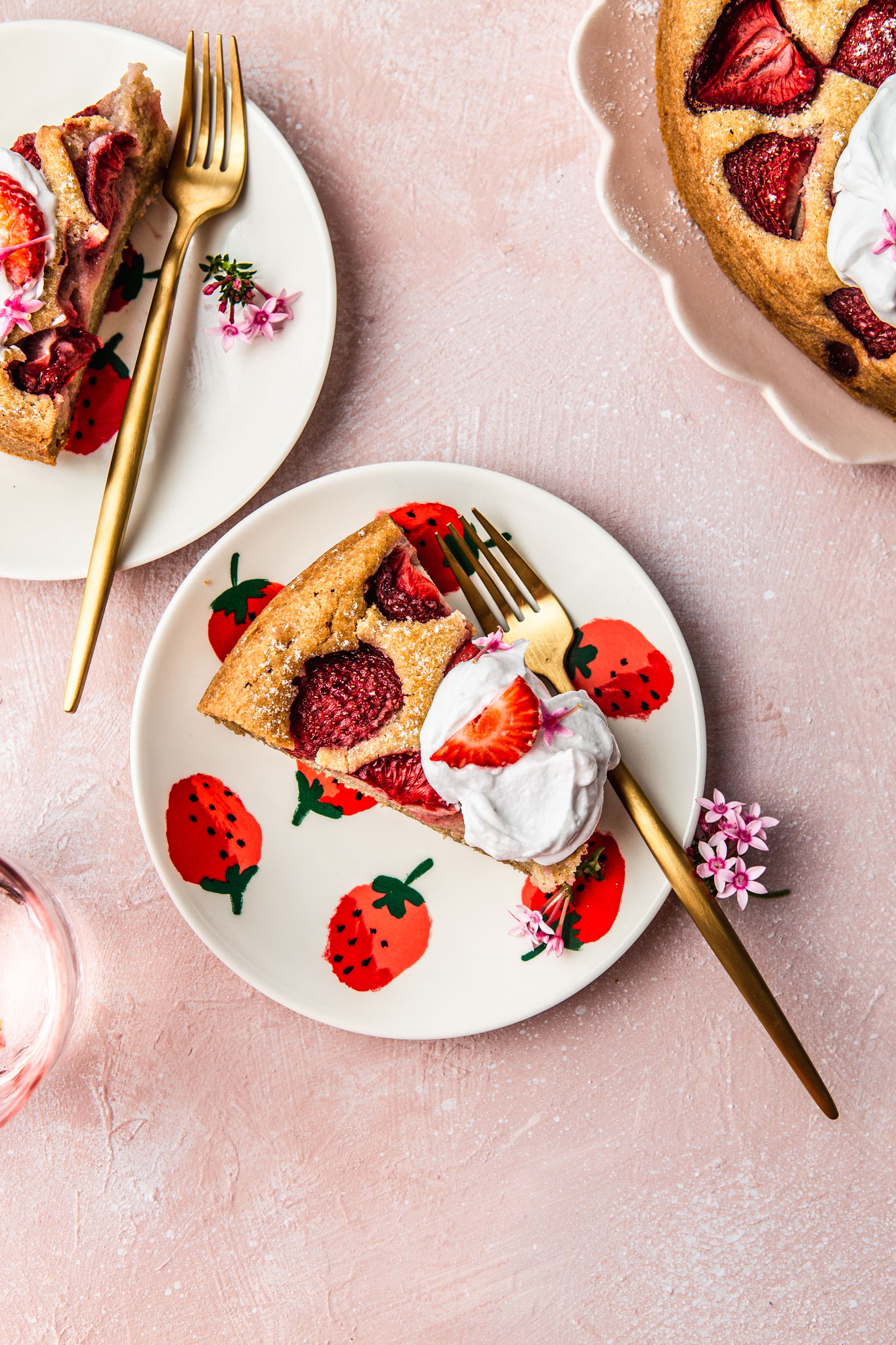 Healthy Fresh Strawberry Cake with Coconut Whipped Cream on strawberry plates