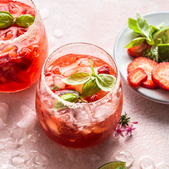 Easy Strawberry Basil Margarita. Such a fun and delicious twist on a traditional margarita recipe! Made with fresh strawberries, basil and sweetened with agave syrup.