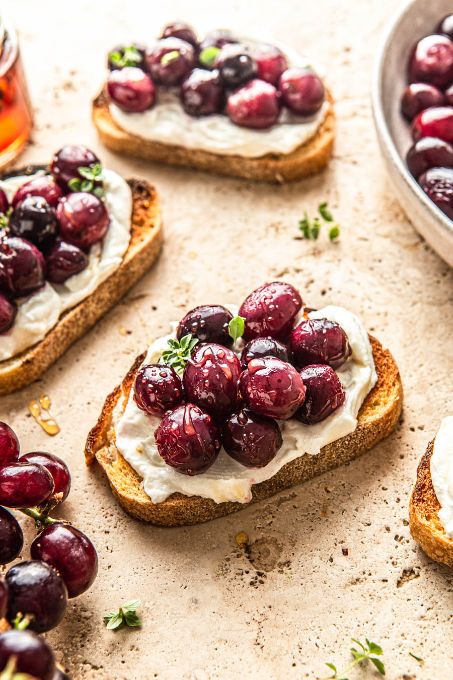 crostini with goat cheese and grapes with thyme and honey drizzle 