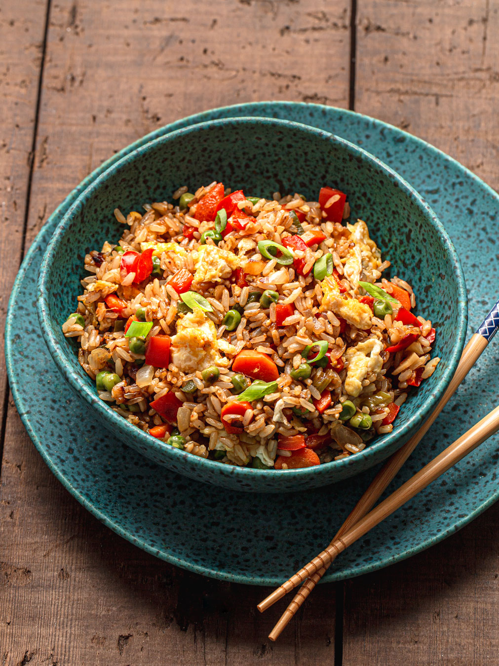 easy Vegetable Fried Rice in blue bowl with chopsticks food photography