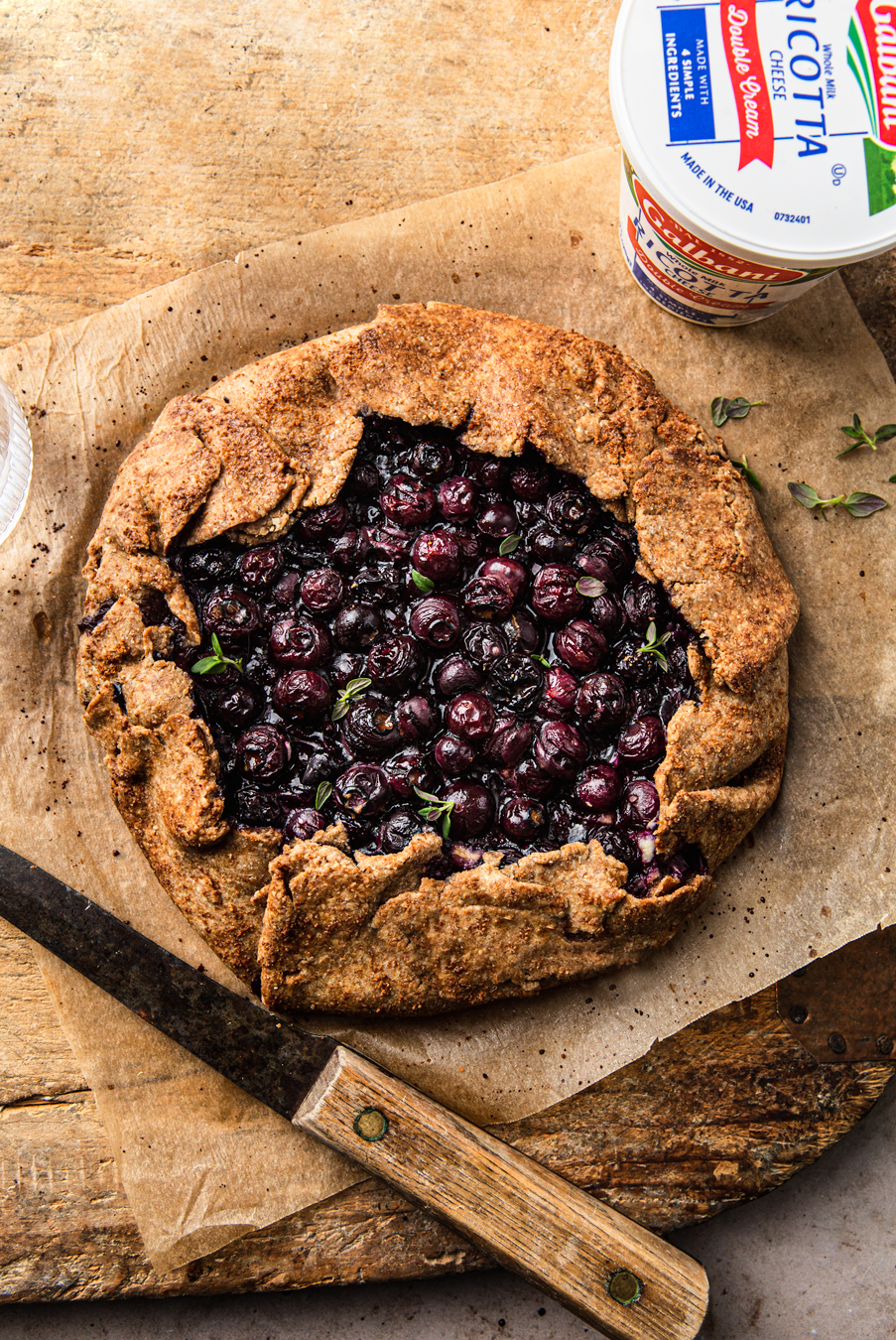 Blueberry Ricotta Galette on a wood cutting board
