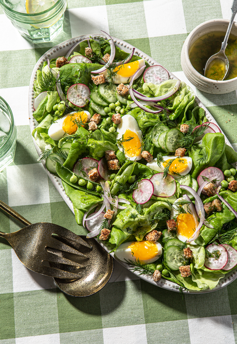 colorful salad with eggs on a check cloth food styling