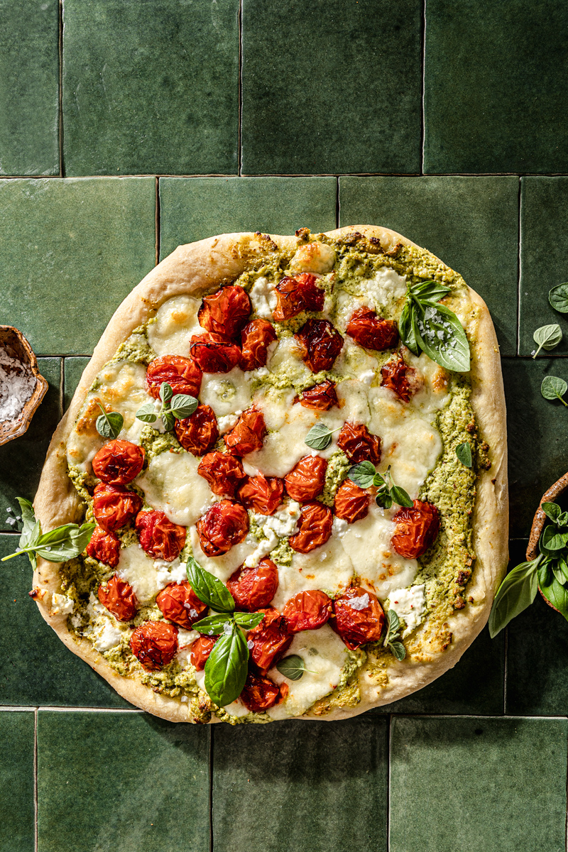 Goat Cheese Pesto Pizza on green tile food photography